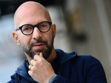 Neil Strauss in glasses and blue hoodie headshot