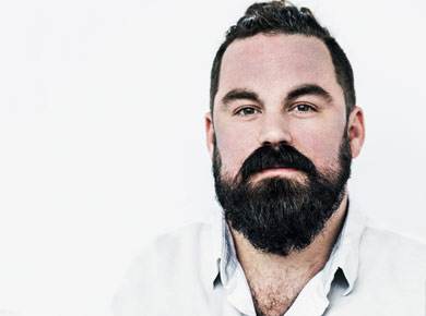 Headshot of Grant Sabatier in an open neck white shirt